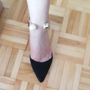 Pearl n gold ankle wrap black shoes .